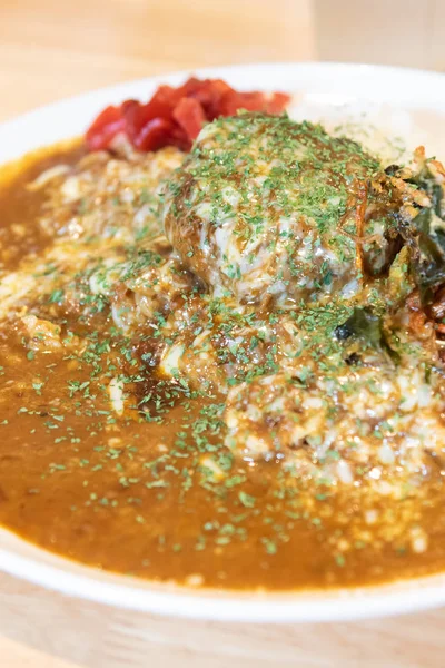 hamburger meat topped with japanese style curry rice.