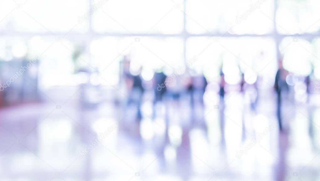  blur image of People standing in office hall.