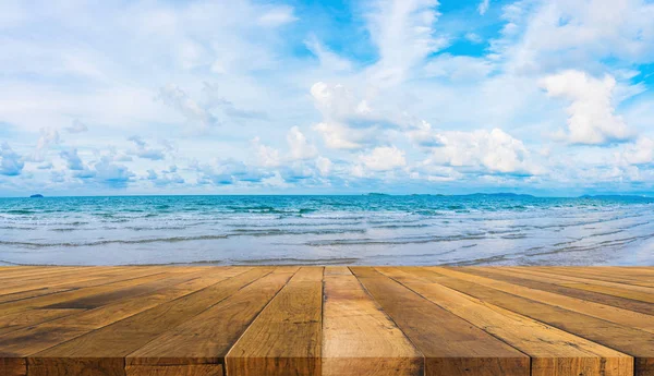  wood table and blue sea and cloudy sky.