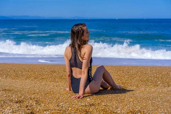 Hossegor, France. 30.06.2020. Soft focus. Beautiful girl sitting near the wavy ocean. Landscape blue background. Outdoor landscape. Beautiful model. Sea ocean. Summer background — Stock Photo, Image
