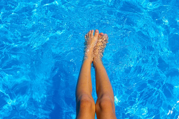 Pies de niño en la piscina. Fondo de enfoque suave. Vacaciones de verano. Hermoso primer plano para el diseño de estilo de vida de lujo.Vacaciones, vacaciones. Cuidado de la piel. Hermoso primer plano de la piscina de pies de niño sobre fondo azul . —  Fotos de Stock