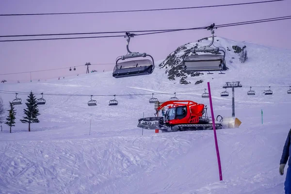 LAlpe DHuez, Fransa 30.12.2019 Daha sonra akşam. Kablo kaldırma kabini arka planı. Özel bir makine yarın için kayak pistini hazırlıyor.. — Stok fotoğraf