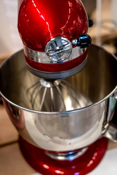 Stainless steel red electric mixer. Hand or stand mixer. Kitchen device. Selective focus macro close-up