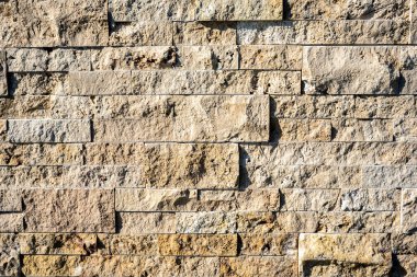 Taş duvar kiremit dokusu arka plan bej yüzey cephesi. Yakın çekim.. 