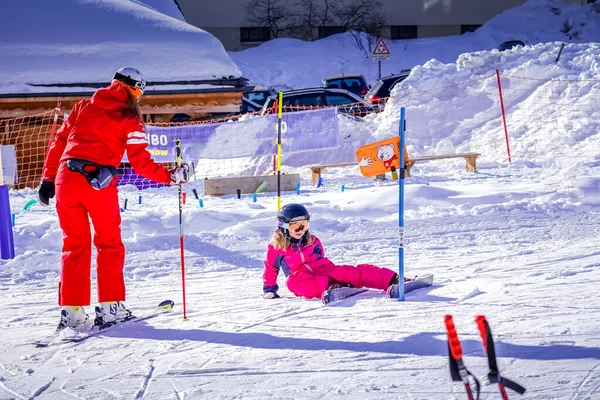 LAlpe DHuez, Fransa 02.01.2019 Profesyonel kayak hocası güneşli bir günde bir çocuğa dağ eteklerinde kayak yapmayı öğretiyor.. — Stok fotoğraf