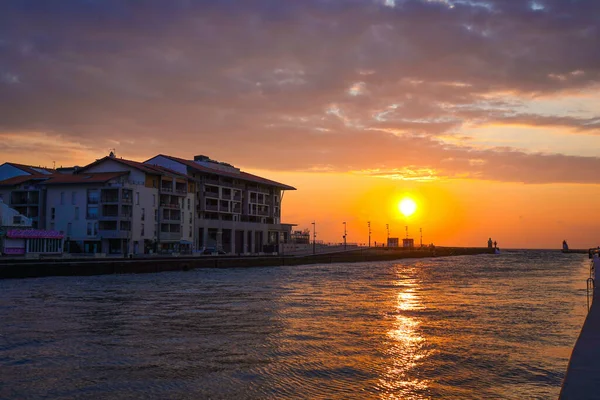 Sea channel view in Capbreton during evening. Beautiful orange sunset. Wallpapers concept