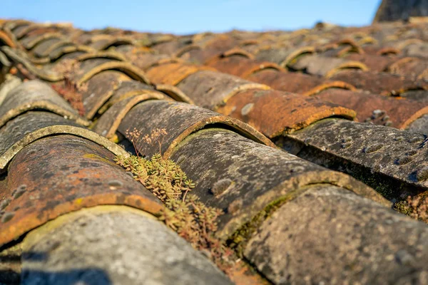 Old and ruined roofs. Texture of a roof with old roof tiles. Macro close up.