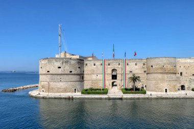 View of the Aragonese Castle with Italian flags to celebrate April 25, Italy's Liberation Day - Taranto, Puglia, Italy clipart