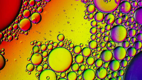Abstract colorful bubbles. Mixing water and oil. Unrealistic colored bubbles, different color filters. Can be used as a festive background, postcard texture.