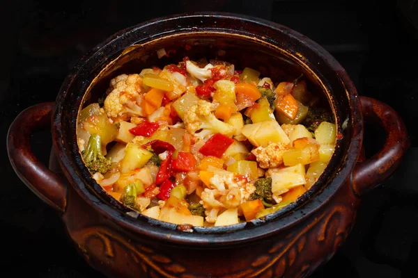 Close-up of a vegetable stew in a pot. Finely chopped various vegetables stewed in a saucepan. National food. Healthy food concept. Vegetarian food concept