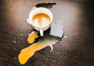 Coffee spilled into a brown wooden floor. The design idea is for an illustration. clipart