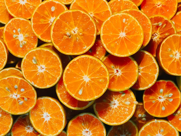 Fresh chopped orange slices food background, Fresh orange color for use in making the background, Orange Slices for sale at the market, Orange cut pieces juicy delicious and healthy fruit fruit drink.