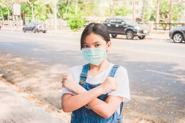 Coronavirus and Air pollution pm2.5 concept.asian girl wearing mask for protect pm2.5 and show stop hands gesture for stop corona virus outbreak.Wuhan coronavirus and epidemic virus symptoms.