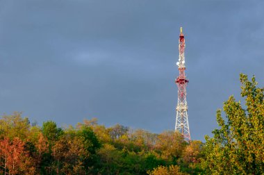 Fırtınalı gökyüzü arka planında radyo kulesi, kara bulutlar