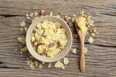 eski ahşap arka plan üzerinde hasır sepet içinde Mısır gevreği