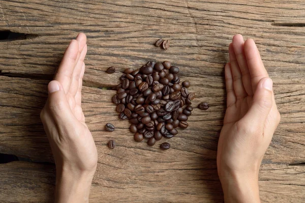 Manos Mujer Sosteniendo Grano Café Mesa Madera — Foto de Stock