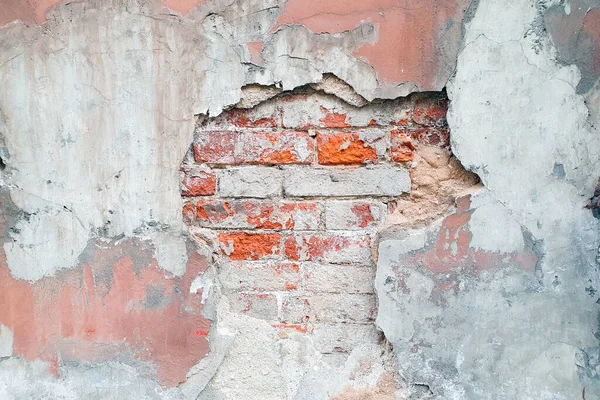 Damaged lgray pink wall texture. Old cracked concrete cement wall. Brick wall with damage.