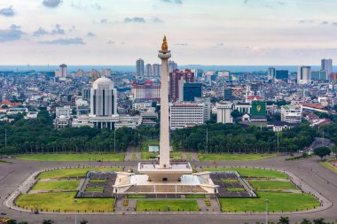 Jakarta, Indonesia - 19th February 2019: Aerial view of Tugu Monas (Monumen Nasional) or National Monument. Jakarta Bay is visible in the far background. clipart