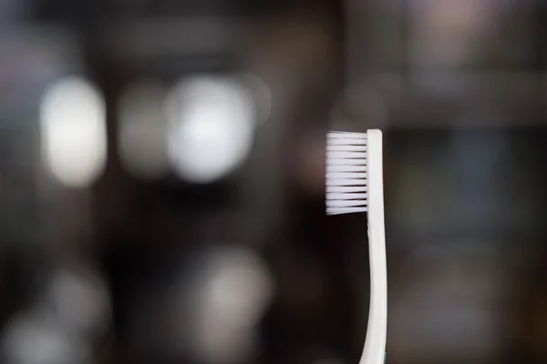 Toothbrush on blurred background. — Stock Photo, Image