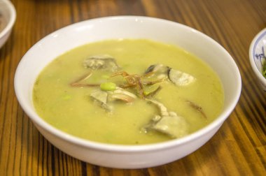 close-up shot of bowl of fish soup on wooden table