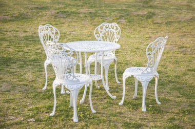 white table and chairs outdoor on green lawn 