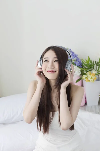 Jovem Mulher Asiática Sentada Cama Ouvindo Música Sorrindo Olhando Para — Fotografia de Stock