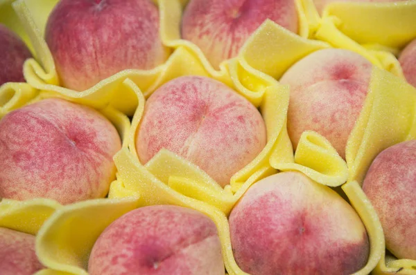 fresh,tasty peaches on background,close up