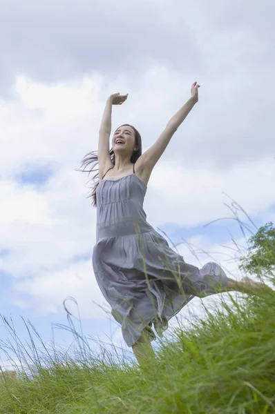 Young Asian woman jump up high and smiling looking away