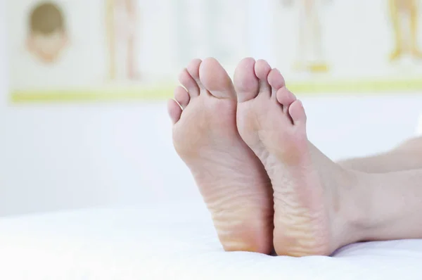 Young Asian woman showing her foot to the camera