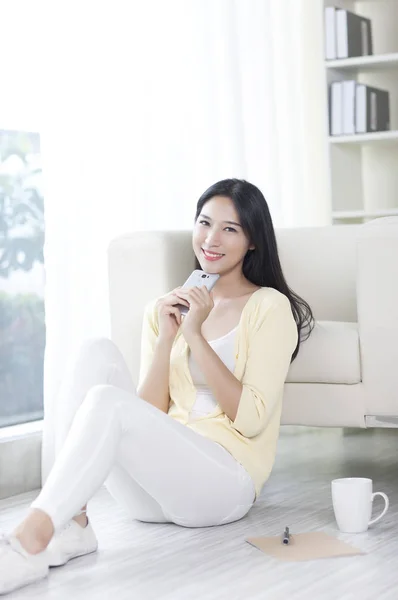 Mujer Joven Sosteniendo Teléfono Inteligente Sonriendo Cámara — Foto de Stock