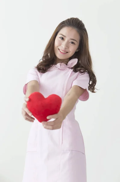 Young Nurse Holding Heart Smiling Camera — ストック写真