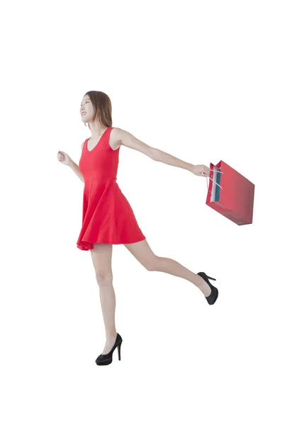 Junge Frau Trägt Rotes Kleid Mit Tasche Und Rennt — Stockfoto