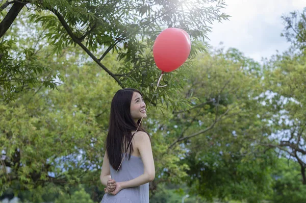 Mladá Asijská Žena Drží Balon Ukazovat Zpět Fotoaparátu — Stock fotografie