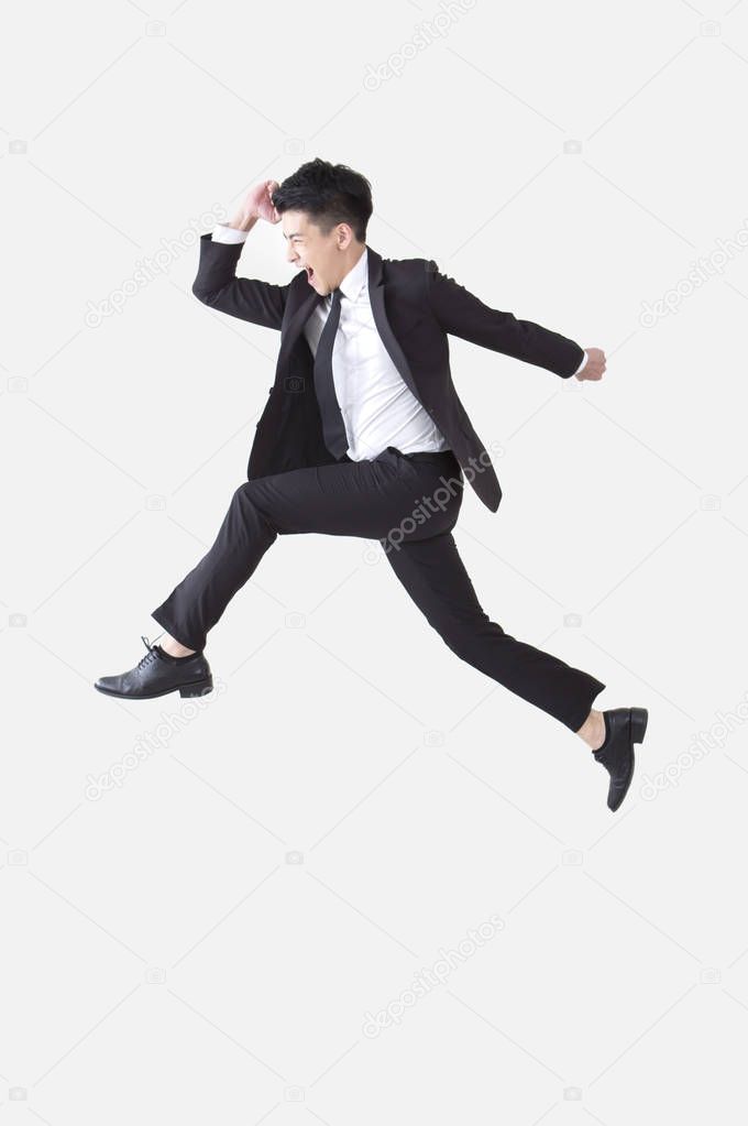 Young Asian man wearing a suit jump up high and smiling