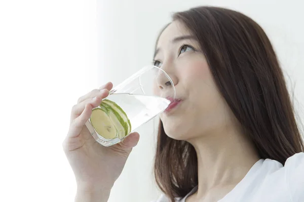 Young Asian woman drinking a lemonade