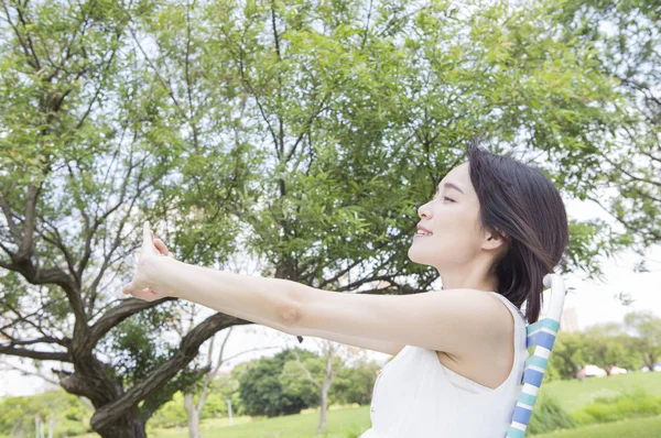 Young Asian Woman Wearing White Dress Sitting Bench Stretching Her — Stock Photo, Image