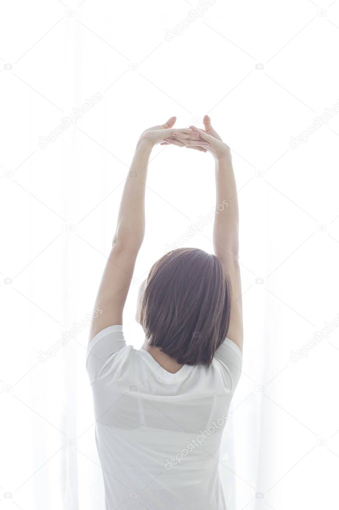 Young Asian woman hands up and stretching her body
