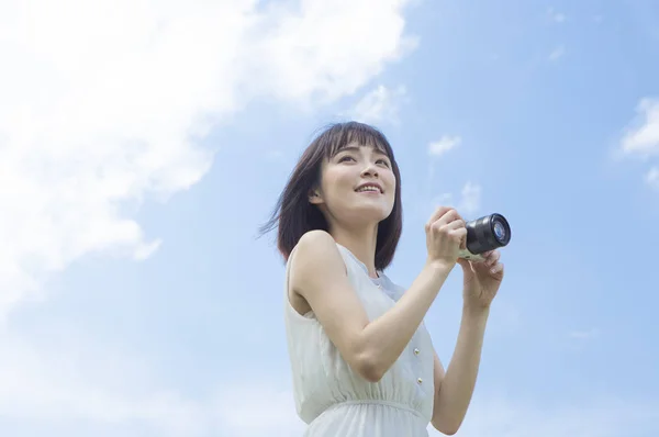 夏の公園でカメラ付きのドレスを着た若いアジアの女性 — ストック写真