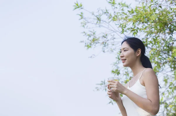 Young asian woman with water at summer park