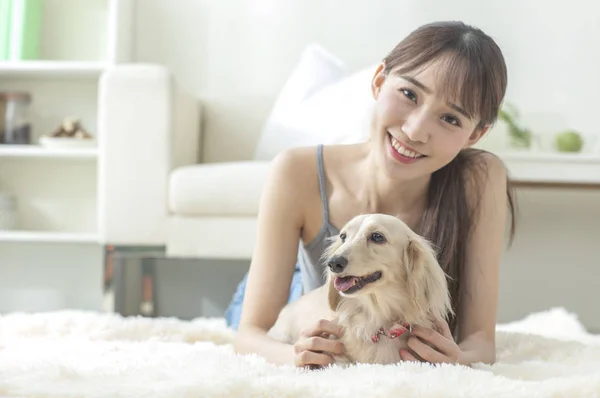 Young Asian woman with dog at home