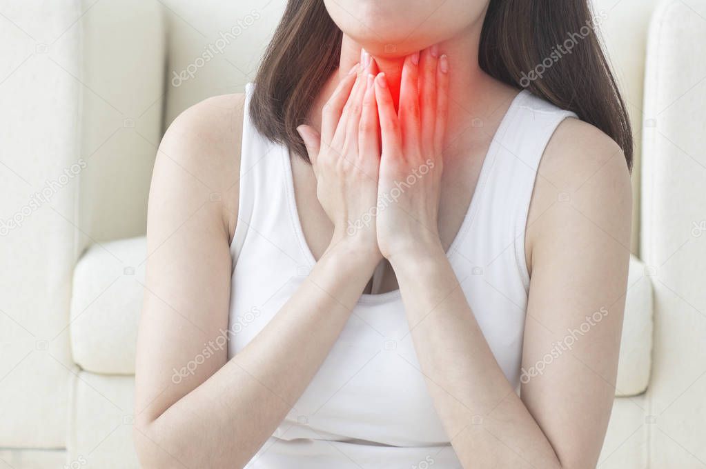  Asian woman suffering from sore throat