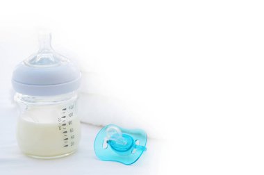 baby bottle and comforter on white background