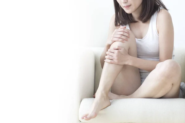 Asian woman injured leg with calf feeling pain.