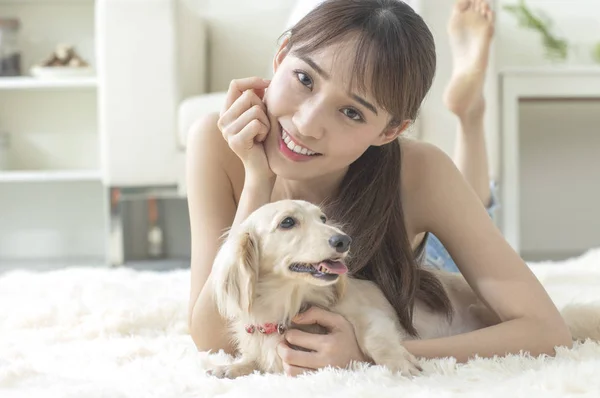 Young Asian woman with dog at home