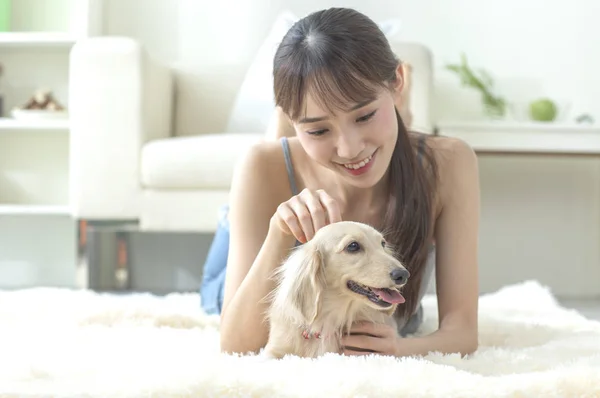 Young Asian woman with dog at home