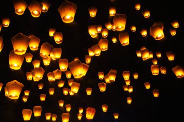 burning lanterns in the night sky