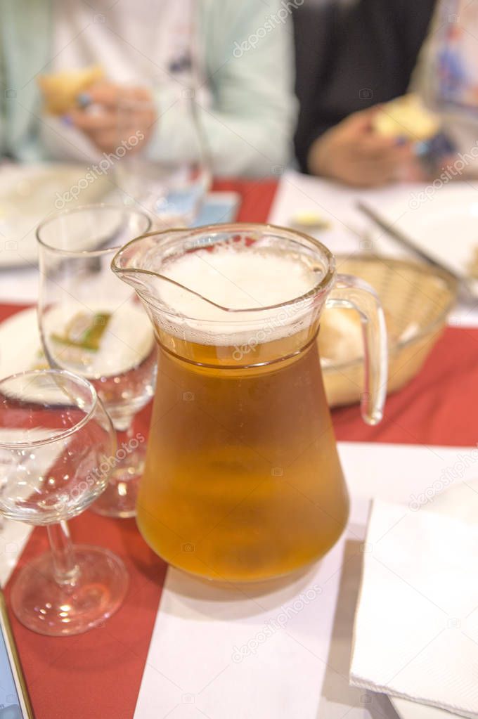 glass jar of beer on dinner table 