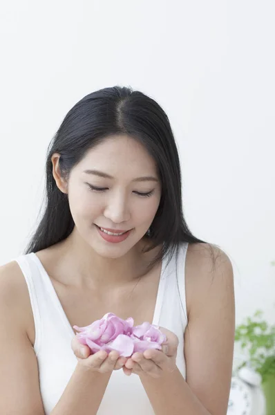 Beautiful Asian woman  with flower petals