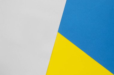 Kağıt dokusu arka planı. Sarı, mavi, gri renk. Çeşitli renklerde bir maddenin düz uzantısı