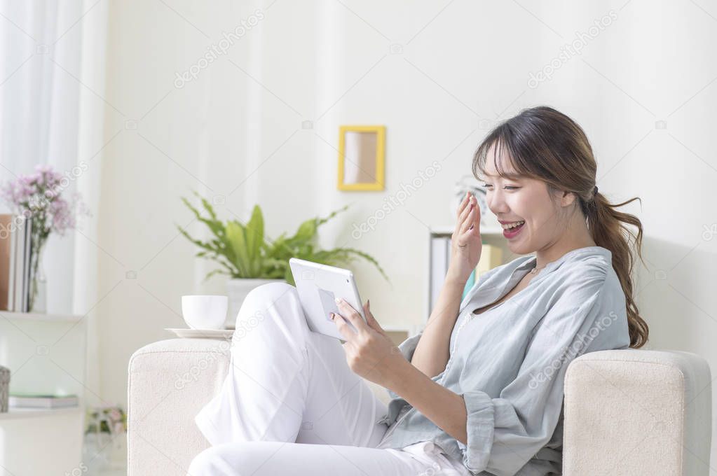portrait of young woman using tablet pc at home